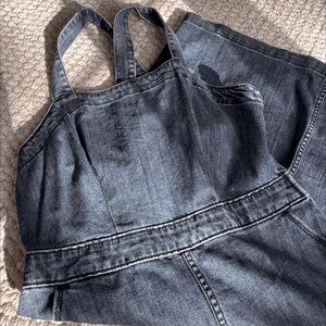 Cross back, denim, midi dress, has pockets and small slit in front.